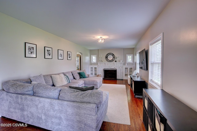 120 Geise St, Sunbury, PA 17801 - living room featuring arched walkways, wood finished floors, and a brick fireplace