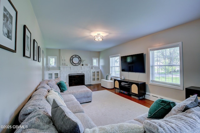 120 Geise St, Sunbury, PA 17801 - living area featuring wood finished floors, a fireplace, and a baseboard radiator