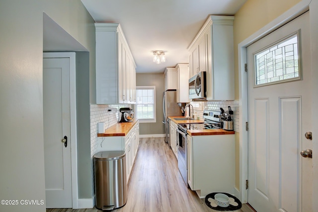 120 Geise St, Sunbury, PA 17801 - kitchen featuring appliances with stainless steel finishes, wood counters, and tasteful backsplash