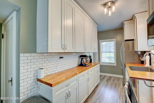 120 Geise St, Sunbury, PA 17801 - kitchen featuring wooden counters, a sink, white cabinetry, and light wood-style floors