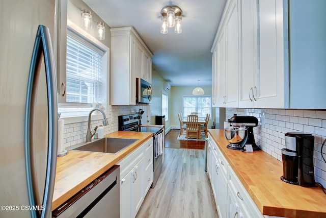 120 Geise St, Sunbury, PA 17801 - kitchen featuring butcher block countertops, stainless steel appliances, a sink, backsplash, and white cabinets