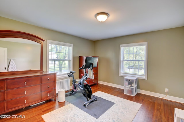 120 Geise St, Sunbury, PA 17801 - workout area with wood finished floors, baseboards, and radiator heating unit