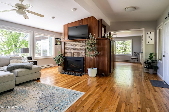78 Trillium Ln, Danville, PA 17821 - living area featuring a baseboard radiator, light wood finished floors, a fireplace, a ceiling fan, and baseboards