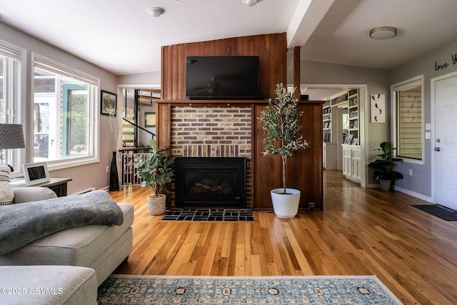 78 Trillium Ln, Danville, PA 17821 - living room with hardwood / wood-style flooring, baseboards, and a brick fireplace
