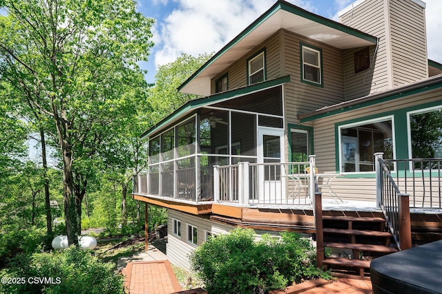 78 Trillium Ln, Danville, PA 17821 - back of property featuring a sunroom, a chimney, and a deck
