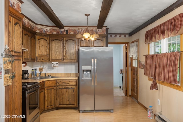 kitchen with stainless steel appliances, a sink, light wood-style flooring, brown cabinetry, and beam ceiling