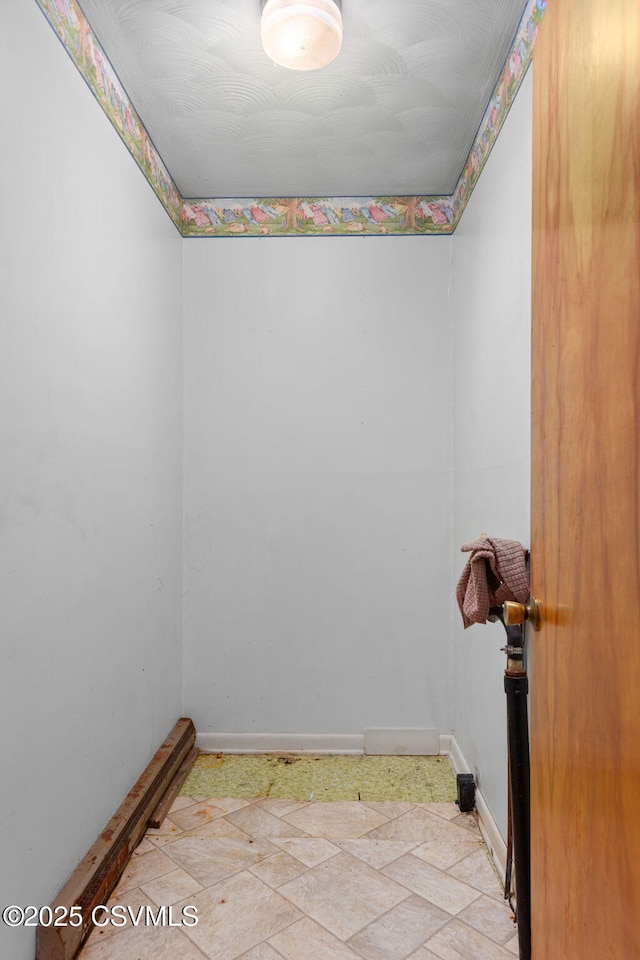 spare room with baseboards