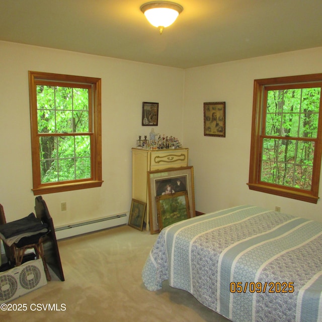 bedroom with a baseboard radiator and carpet