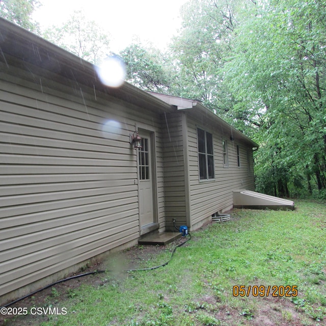 view of side of property with a yard