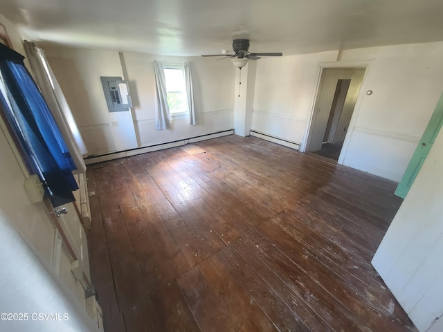 spare room with wood-type flooring, a baseboard heating unit, ceiling fan, and electric panel