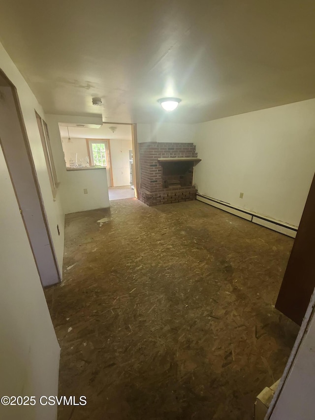 unfurnished living room featuring a brick fireplace and a baseboard radiator