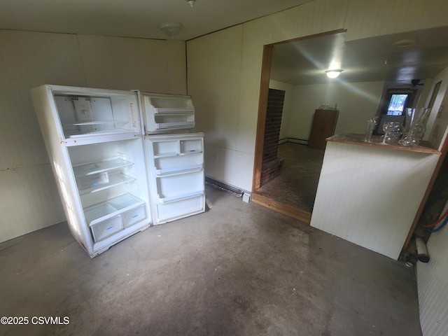 unfurnished room featuring concrete flooring and a fireplace