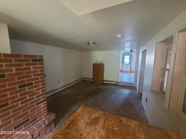 unfurnished living room featuring a baseboard heating unit, ceiling fan, and baseboard heating