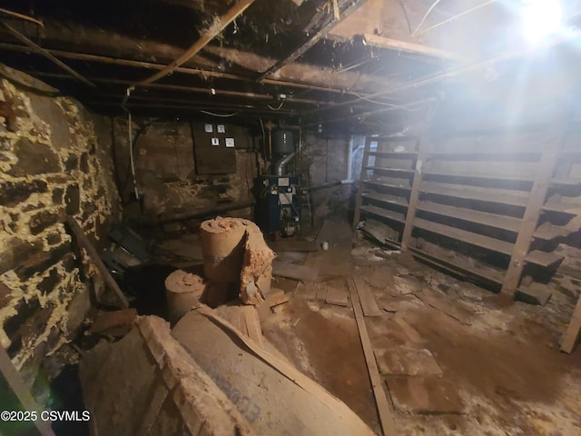 unfinished basement with a heating unit and electric panel