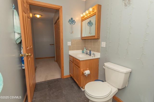half bath with backsplash, vanity, toilet, and baseboards