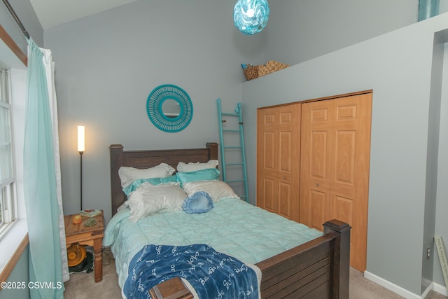bedroom featuring light colored carpet and a closet