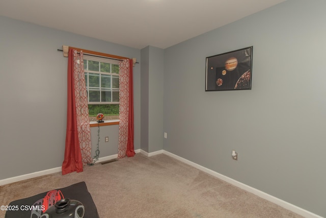 spare room with carpet floors and baseboards