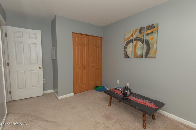 unfurnished room with carpet flooring and baseboards
