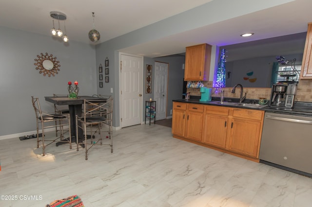 kitchen featuring dishwasher, a sink, tasteful backsplash, dark countertops, and brown cabinetry
