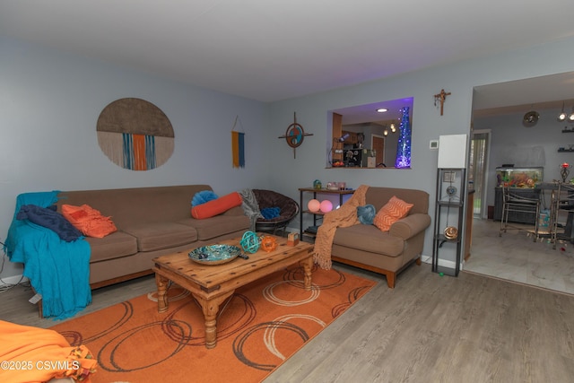 living area with wood finished floors and baseboards