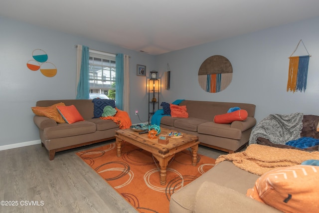living area featuring wood finished floors and baseboards