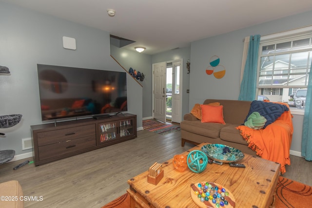 living area with wood finished floors and baseboards