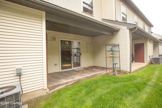 back of house featuring a patio, central air condition unit, and a lawn