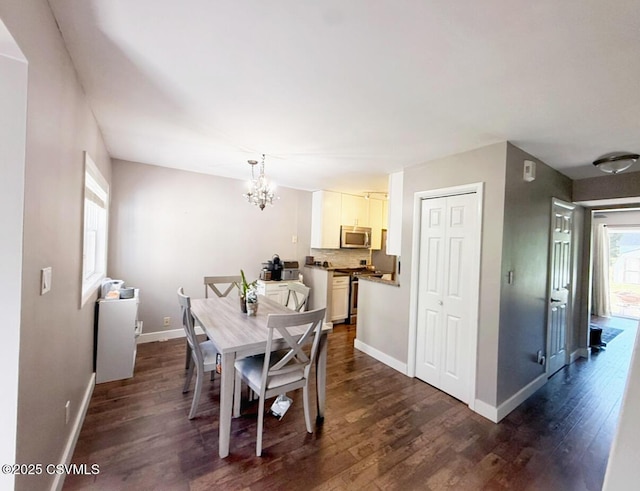172 Ivy Ln, Danville, PA 17821 - dining area featuring a chandelier, dark wood-style floors, and baseboards