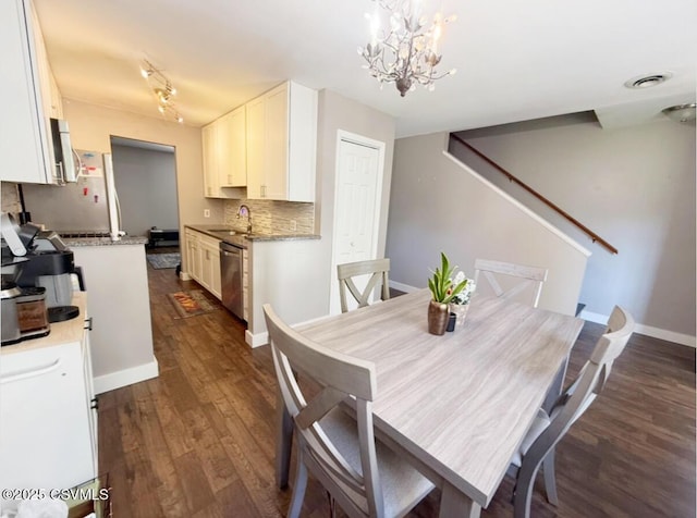 172 Ivy Ln, Danville, PA 17821 - dining area featuring dark wood-style flooring, a chandelier, and baseboards