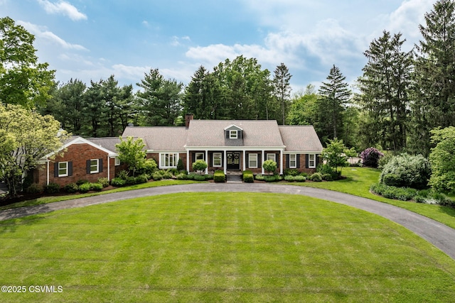 304 Hardscrabble Ln, Lewisburg, PA 17837 - view of front of house featuring curved driveway, covered porch, a front lawn, a chimney, and brick siding