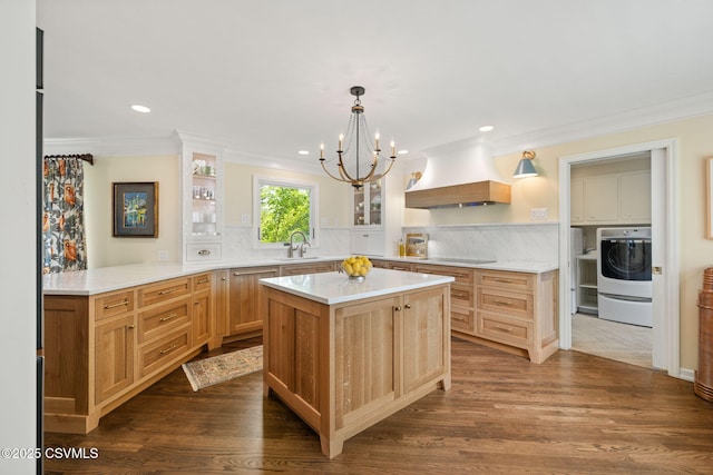 304 Hardscrabble Ln, Lewisburg, PA 17837 - kitchen with custom exhaust hood, washer / dryer, crown molding, a sink, and a chandelier