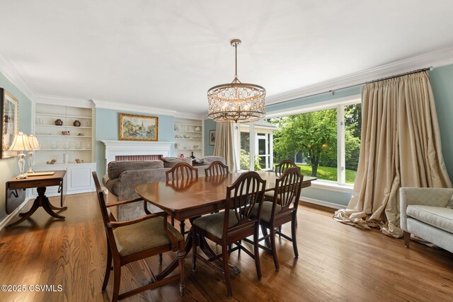 304 Hardscrabble Ln, Lewisburg, PA 17837 - dining room with a chandelier, wood finished floors, crown molding, baseboards, and a fireplace