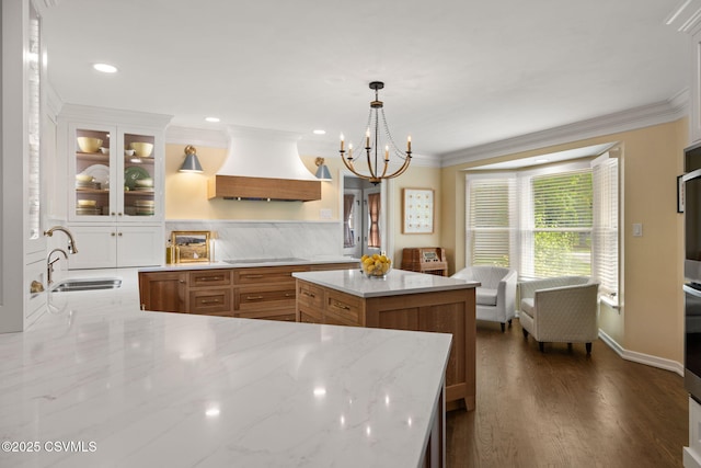 304 Hardscrabble Ln, Lewisburg, PA 17837 - kitchen featuring custom exhaust hood, a sink, ornamental molding, glass insert cabinets, and light stone countertops