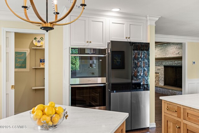 304 Hardscrabble Ln, Lewisburg, PA 17837 - kitchen featuring appliances with stainless steel finishes, a chandelier, light stone counters, white cabinetry, and dark wood-type flooring