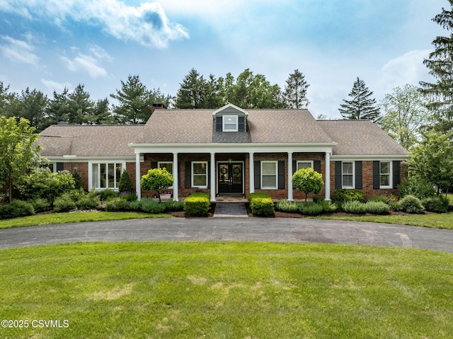 304 Hardscrabble Ln, Lewisburg, PA 17837 - view of front of house featuring a front yard, driveway, covered porch, brick siding, and a chimney