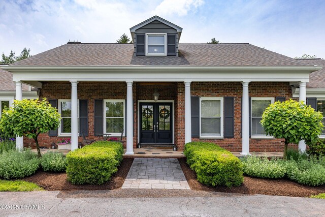 304 Hardscrabble Ln, Lewisburg, PA 17837 - view of exterior entry featuring brick siding, a shingled roof, a porch, and french doors