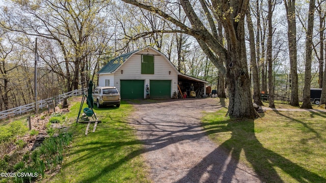 view of property exterior with a detached garage, an outdoor structure, dirt driveway, and a barn