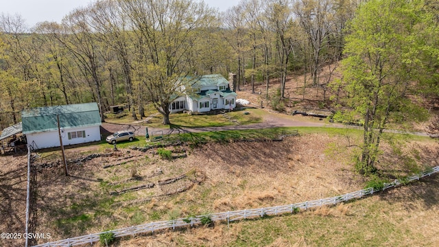 view of yard featuring fence and a forest view