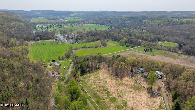 aerial overview of property's location featuring rural landscape and a heavily wooded area