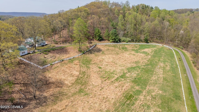 aerial view of property and surrounding area with a forest