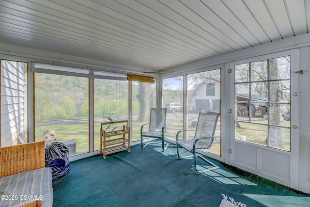 sunroom / solarium featuring carpet flooring