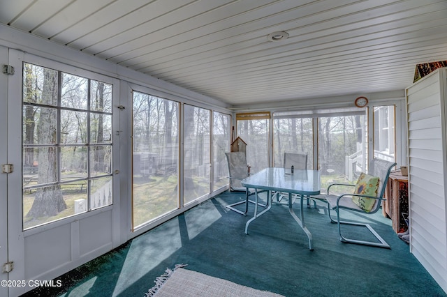 sunroom featuring healthy amount of natural light and outdoor dining space