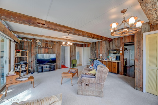 living area with wooden walls, a chandelier, carpet floors, and beamed ceiling