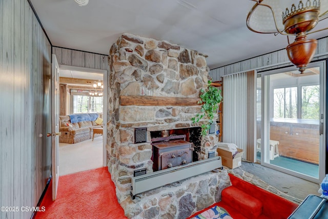 carpeted living room featuring baseboard heating and a fireplace