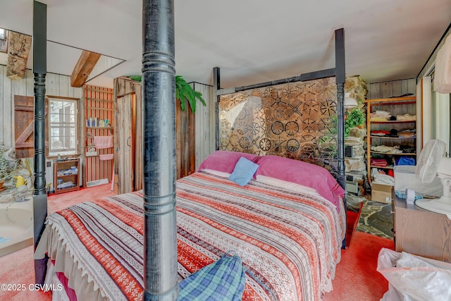 bedroom with carpet flooring and wood walls
