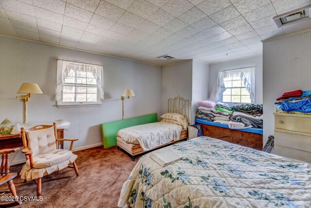 carpeted bedroom with wallpapered walls