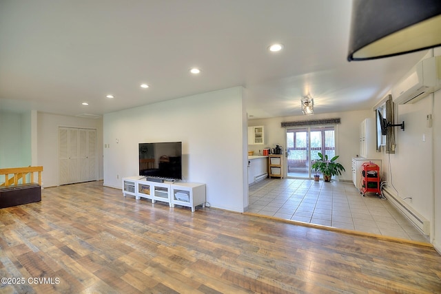 110 W 7 Th St, Mifflinville, PA 18631 - living area featuring a wall mounted AC, a baseboard radiator, wood finished floors, and recessed lighting