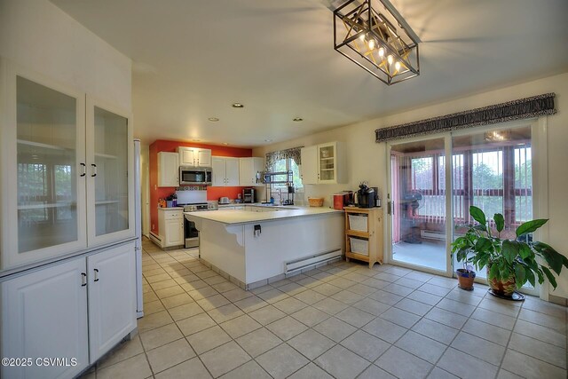 110 W 7 Th St, Mifflinville, PA 18631 - kitchen with appliances with stainless steel finishes, a baseboard heating unit, light tile patterned floors, a sink, and recessed lighting