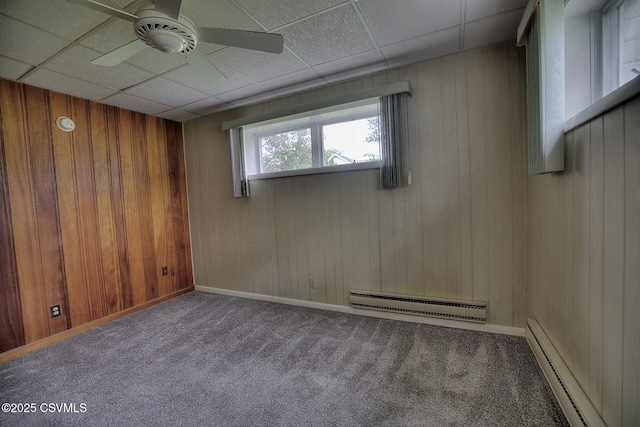 110 W 7 Th St, Mifflinville, PA 18631 - below grade area with a baseboard radiator, carpet flooring, ceiling fan, wooden walls, and a drop ceiling