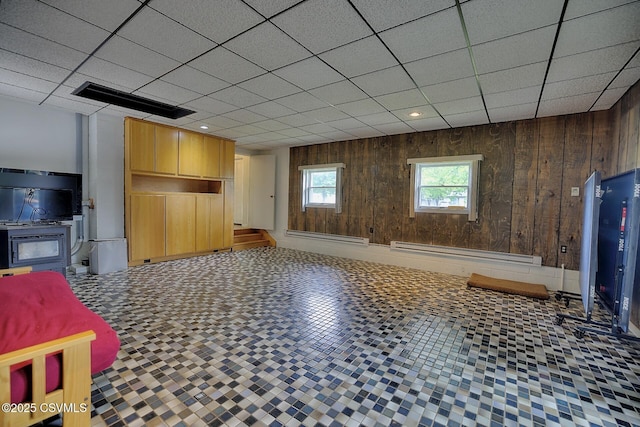 110 W 7 Th St, Mifflinville, PA 18631 - unfurnished living room with a baseboard heating unit, wood walls, a baseboard radiator, and a paneled ceiling